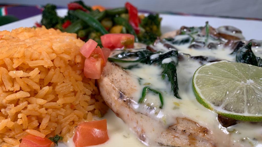 Pollo Loco · Chicken breast topped with mushroom, bell pepper, onions, and rice. Served with rice, cheese dip, and steamed vegetables.