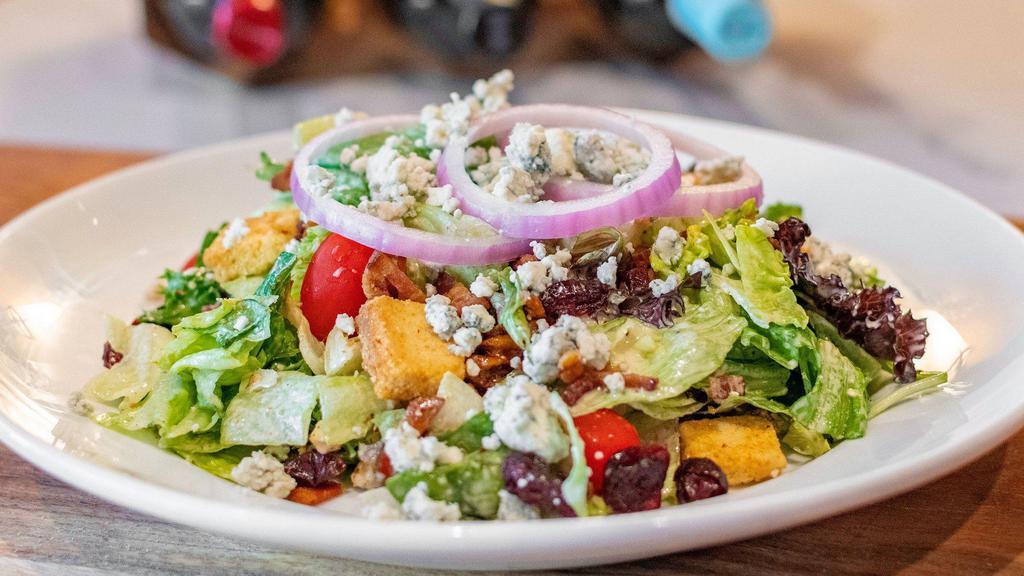 Stonewood Salad · Fresh mixed greens, bacon, bleu cheese crumbles, grape tomatoes, dried cranberries, red onion, blackened walnuts, croutons and a side of bleu cheese house vinaigrette.