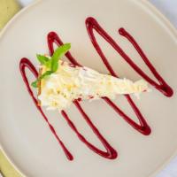 House-Made Key Lime Pie · Graham cracker crust with a tart and tangy filling and a side of raspberry puree and whipped...
