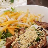 Grilled Pork With Rice Vermicelli · Vermicelli noodle served with bean sprouts, lettuce, cucumbers, cilantro, peanuts, papaya, a...