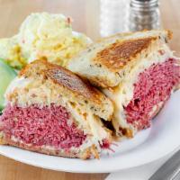 Our Famous Reuben · Corned beef, pastrami, turkey or turkey pastrami with sauerkraut, Russian dressing and melte...
