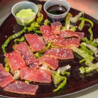 Ahi Tuna Salad · Sushi grade tuna seared on top of a bed of lettuce with tomato, cucumber, onion and croutons.