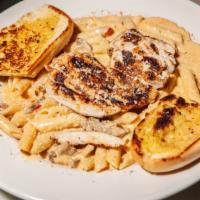 Cajun Chicken Pasta · Blackened Chicken, mushrooms, tomato, Cajun alfredo sauce, served with penne pasta and garli...