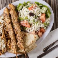Souvlaki Platter · Two skewers of marinated pork or chicken served with grilled and sliced pita, tzatziki and c...