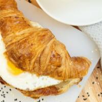 Runny Egg Croissant · Crispy bacon, runny egg and mixed greens
