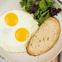 Sunny Side Up Eggs · Mixed greens and toast.