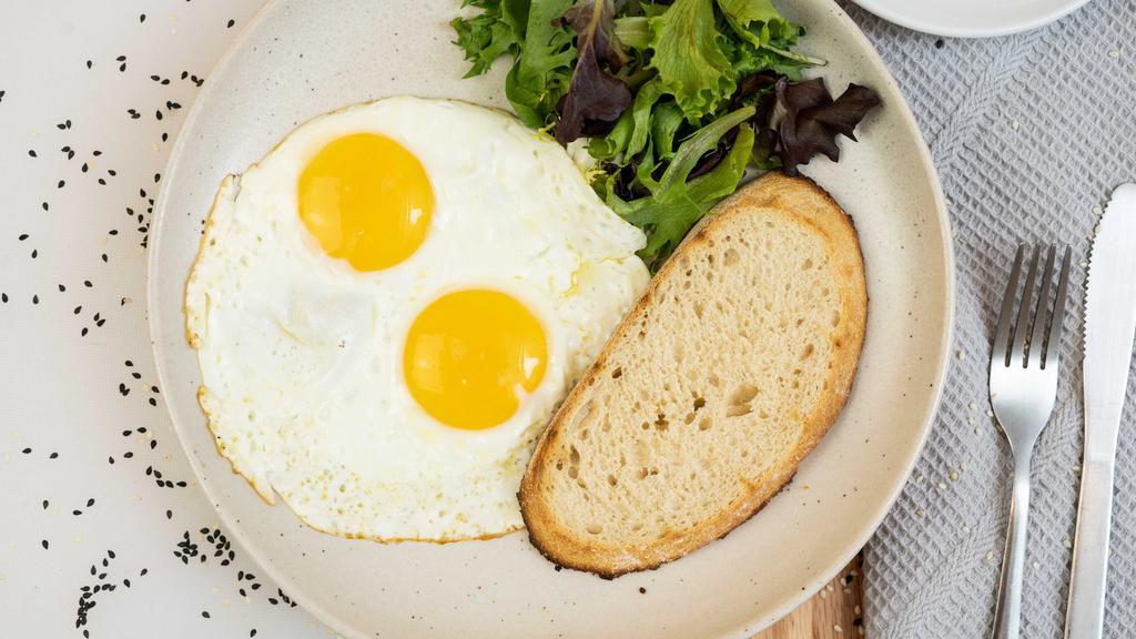 Sunny Side Up Eggs · Mixed greens and toast.