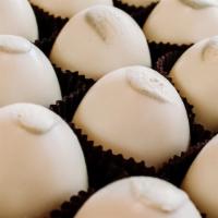 Key Lime Pecan Truffle · White chocolate key lime truffle with a twist of lemon covered in white chocolate on a base ...