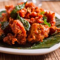 Gobi 65 · Deep fried cauliflower tossed with green chillies, curry leaves, and spices.