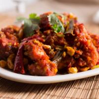 Guntur Chicken · Spicy. Boneless chicken sautéed with dry red chilies and curry leaves.