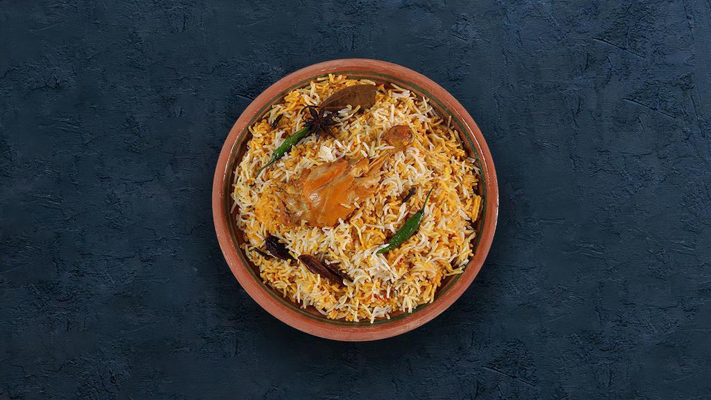 Chicken Biryani · Long grain basmati rice cooked with tender chicken and aromatic Indian herbs.