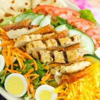 Grilled Chicken Club Salad · Mixed greens, tomatoes, sliced cucumbers, shredded carrots, egg, shredded cheddar, grilled c...