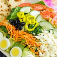 Greek Salad · Garden salad, mixed with feta cheese, black olives, green peppers, and banana peppers. Toppe...