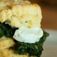 The Iron Goat · Flaky biscuit, goat cheese medallion, and sautéed spinach. (646 cal.)