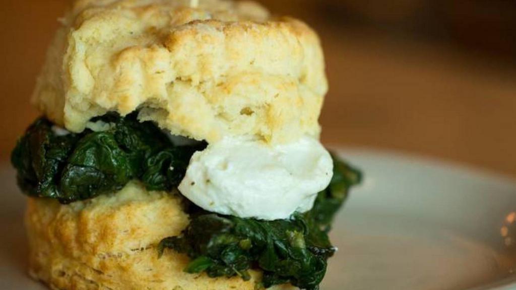 The Iron Goat · Flaky biscuit, goat cheese medallion, and sautéed spinach. (646 cal.)