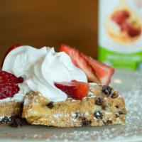 Little Grace · Half of a chocolate chip waffle topped with strawberries, powdered sugar, whipped cream and ...
