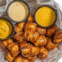 Pretzel Bites · Served with spicy mustard, queso dip and honey mustard .
