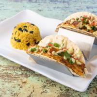 Baja Fish Tacos Duo · Warm tortillas piled high with crunchy cabbage, fresh dicedtomatoes and garlic herb crusted ...