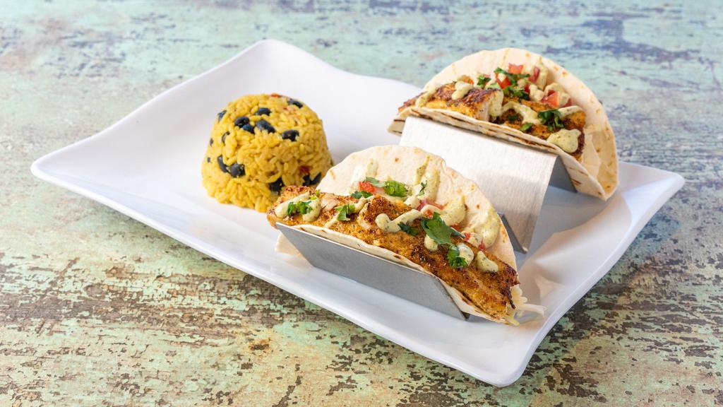 Baja Fish Tacos Duo · Warm tortillas piled high with crunchy cabbage, fresh dicedtomatoes and garlic herb crusted mahi. Finished off with a drizzle ofour Homemade Pesto Aioli and chopped fresh cilantro.