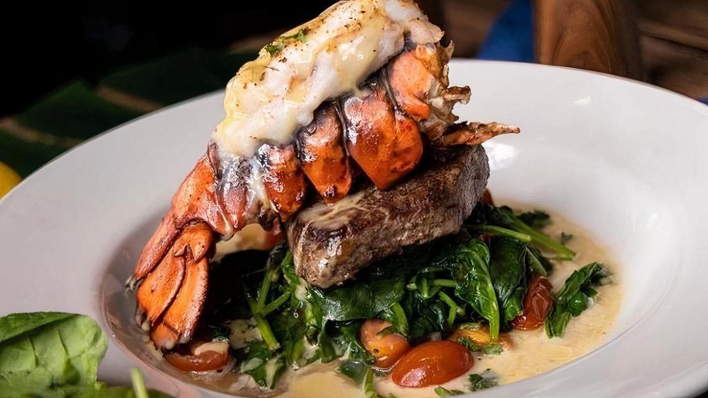 Surf & Turf · 6 oz of fillet mignon topped with 6 oz lobster tail, spinach, cafe de Paris sauce. Served w/ a side of basmati rice.
