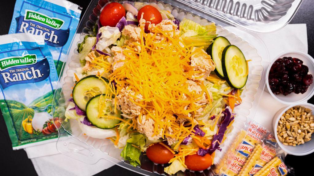 Bbq Super Salad · A bed of romaine mix with grape tomatoes, cucumbers, shredded cheese, topped with your choice of meat served with 2 dressing packets and cafe crackers. Includes dried cranberries and sunflower seeds on the side.