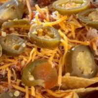 Bbq Nachos · Crunchy corn tortilla chips topped with queso sauce, choice of meat, then drizzled with our ...