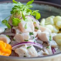 Ceviche Tradicional With Rocoto · Slices of fresh fish marinated lightly in lime juice and seasoned with Peruvian limo chili, ...