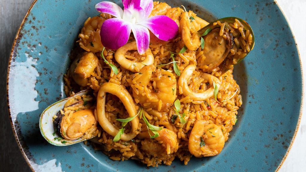Arroz Con Mariscos · Shrimp, squid, mussels and scallops, all mixed with rice, red pepper, cilantro, and Peruvian panca pepper dressing.