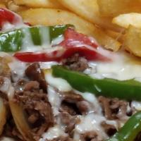 Philly Cheesesteak · Shaved rib eye seasoned and grilled with peppers, onions, covered with mozzarella and served...