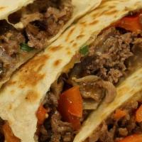 Steak Quesadilla · Grilled Steak with peppers, onions, and cheddar cheese served with sour cream