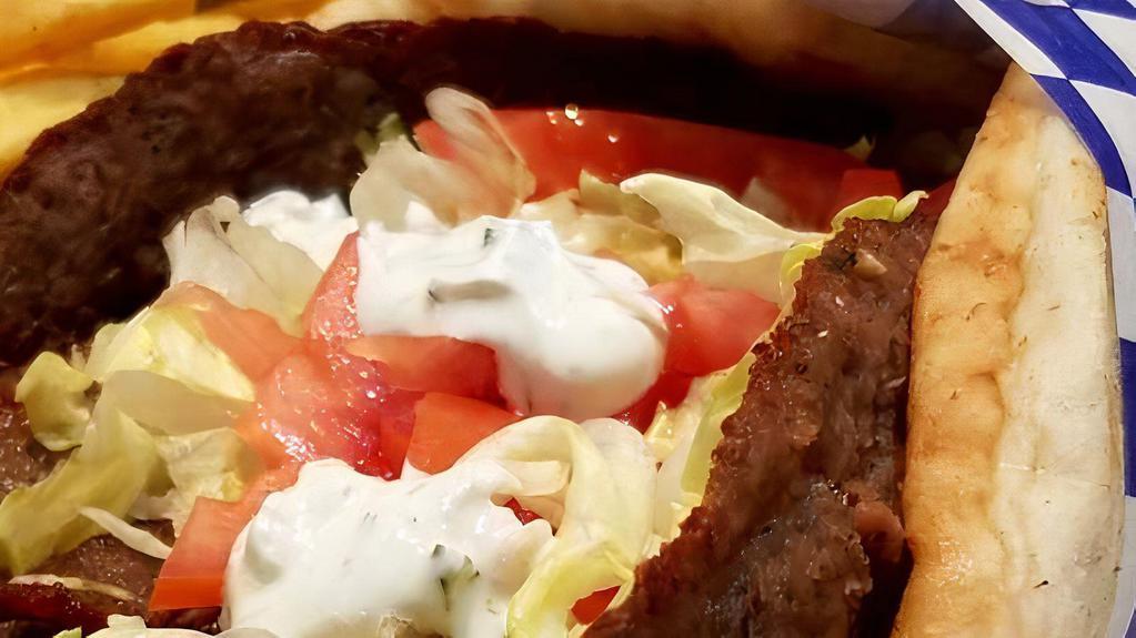 Lamb Gyro · Greek style seasoned lamb cooked on a spit and wrapped in a pita with lettuce, tomato, and a side of tzatziki sauce.