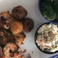 Shrimp Basket · Grilled, blackened or cajun, with our famous shrimp slaw, two hushpuppies, a corn fritter an...
