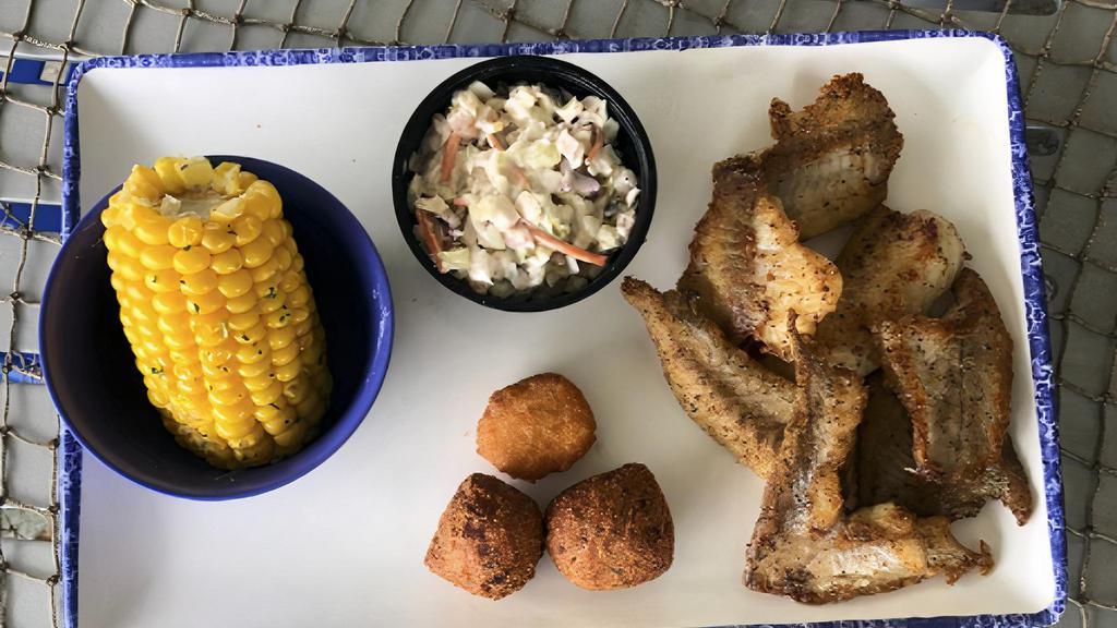 Catfish Platter (Cal 670) · Grilled, blackened or cajun, with our famous shrimp slaw, two hushpuppies, a corn fritter and your choice of an additional side