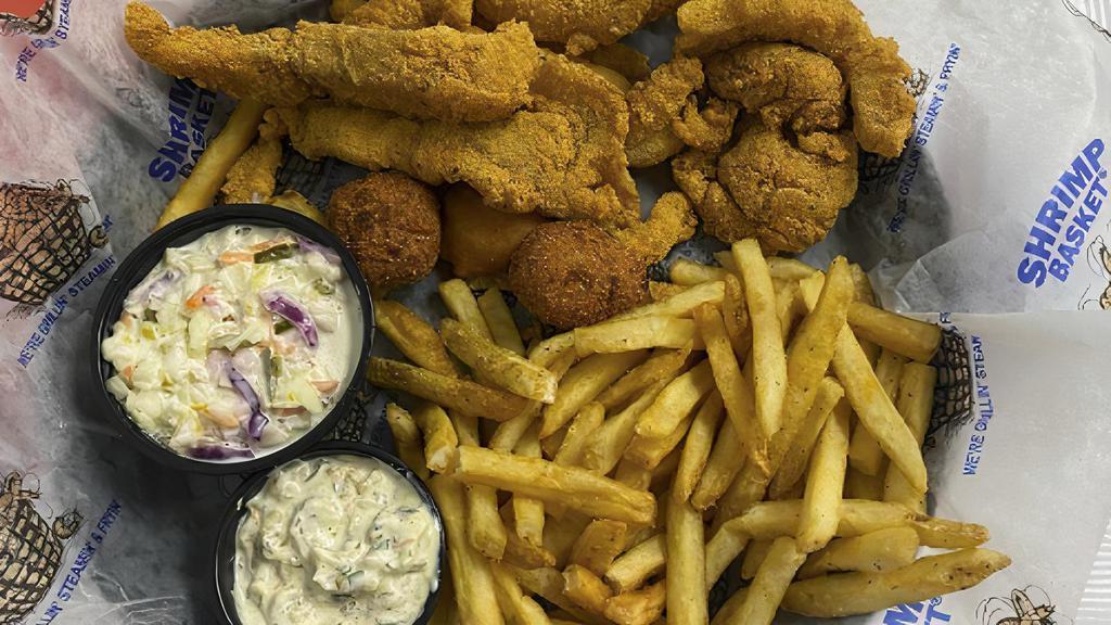 Catfish Basket (Cal 1140) · Farm-raised USA Catfish handbattered and lightly fried, served with our signature shrimp slaw, two hushpuppies, one corn fritter and french fries.