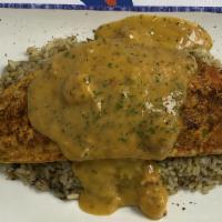 Blackened Redfish (Cal 630) · with seafood cream sauce, served on a bed of rice.
