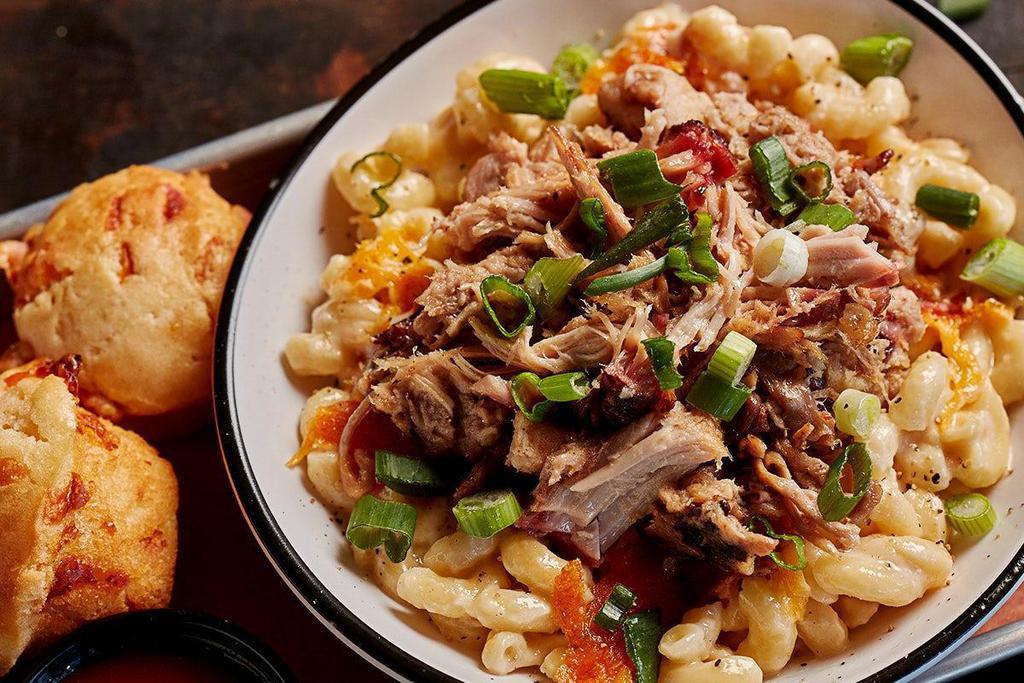 Loaded Mac & Cheese · Our famous mac & cheese topped with barbecue pork and scallions. . (This item does not include two trimmings.)