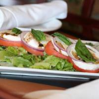 La Caprese · Vine ripe tomatoes, fresh mozzarella cheese, fresh basil and red onions served with a side o...