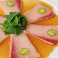 Yellowtail Jalapeno · Raw/under cooked. Generous slices of yellowtail topped with a slice of jalapeno chili pepper...