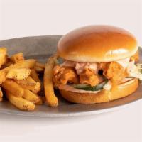 Saucy Buffalo Tender Sandwich · 3 hand-breaded crispy chicken tenders served on buttery brioche bun with house made pickles ...