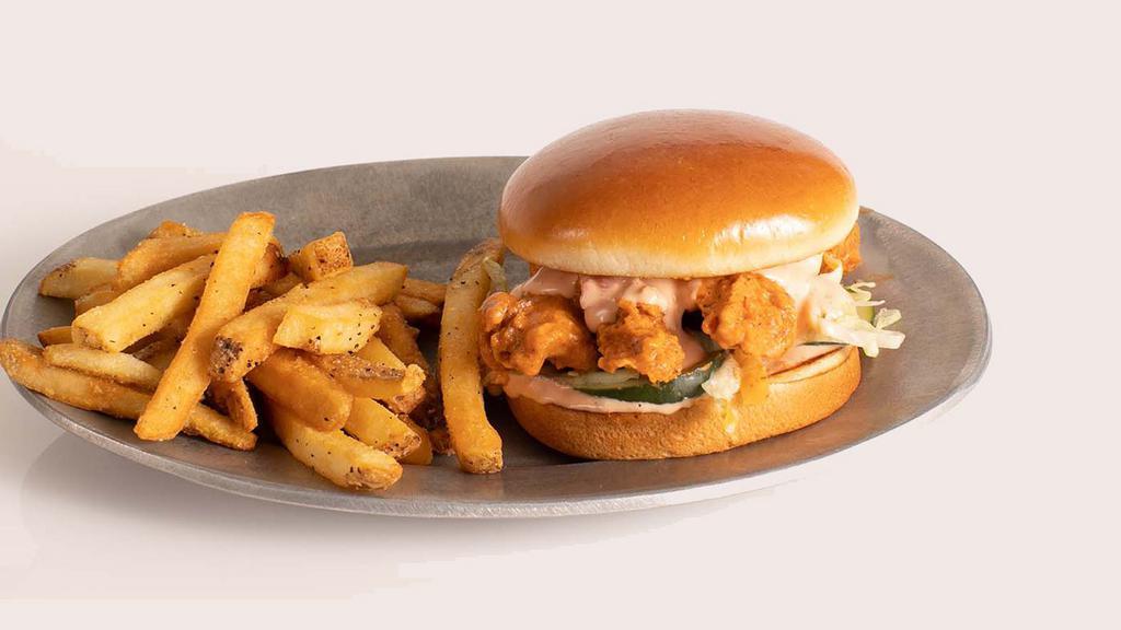 Saucy Buffalo Tender Sandwich · 3 hand-breaded crispy chicken tenders served on buttery brioche bun with house made pickles and shredded lettuce. Served with a side of seasoned fries or upgrade your side to Mac & Cheese for $1 more.