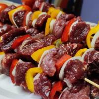 Shish Kebab · Skewer of tender marinated beef with lettuce, tomatoes, onion, pickles, and garlic.