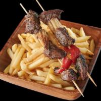Pinchos · Grilled chicken or steak with onions and tomato served over a bed of fries (extra charge for...