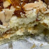 Caramel Marquesa / Marquesa De Caramelo · Layered vanilla cake and almond cream topped with crunchy caramel and almond slices. Served ...