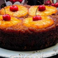 Pineapple Cake / Torta De Piña · Vanilla cake topped with caramelized pineapple. Served by the slice. 
Bizcocho de vainilla c...
