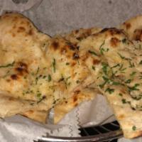 Garlic Naan · Unleavened white flour bread baked with fresh garlic and cilantro