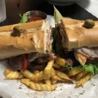 Chivito Sandwich · Thin beef meat, fried eggs, sweet pepper, ham, bacon, lettuce, tomatoes, sauteed onions and ...