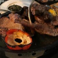 Parrillada For 1 Person · Short ribs, 1 sausage, 1 blood sausage, and grilled veggies.