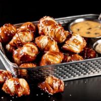 Pretzel Dippers · Hot, bite-sized pretzels baked & served with warm, signature queso & Bavarian pub-style must...