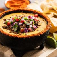 Loaded Queso & Chips · Three-cheese queso loaded with seasoned ground beef & fresh pico de gallo, served with crisp...