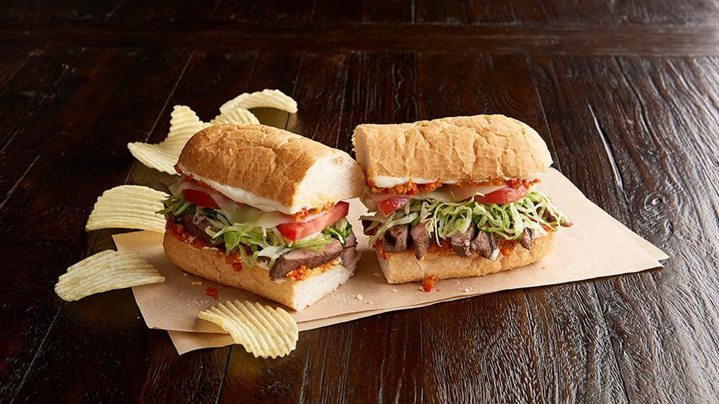 Steak Po'Boy Regular · Sirloin steak cooked medium,* spicy piquillo pepper relish, provolone, shredded lettuce, Roma tomato, mayo toasted New Orleans French bread. Served with chips or baked chips (150/100 cal) and a pickle (5 cal).